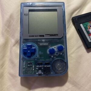 Game boy pocket with 5 games included. Game boy glows in the dark.